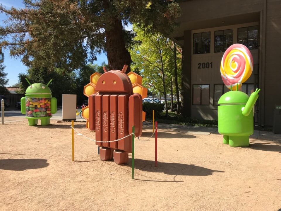 android mascot figures in a candy themed park