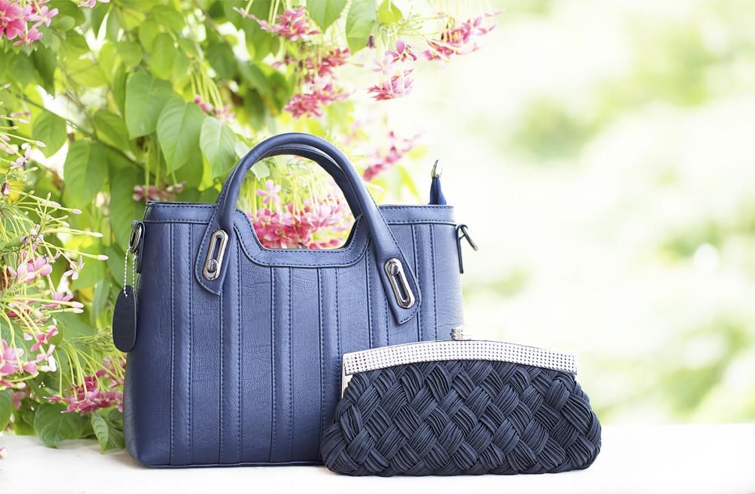 a navy woman's bag and a black clutch